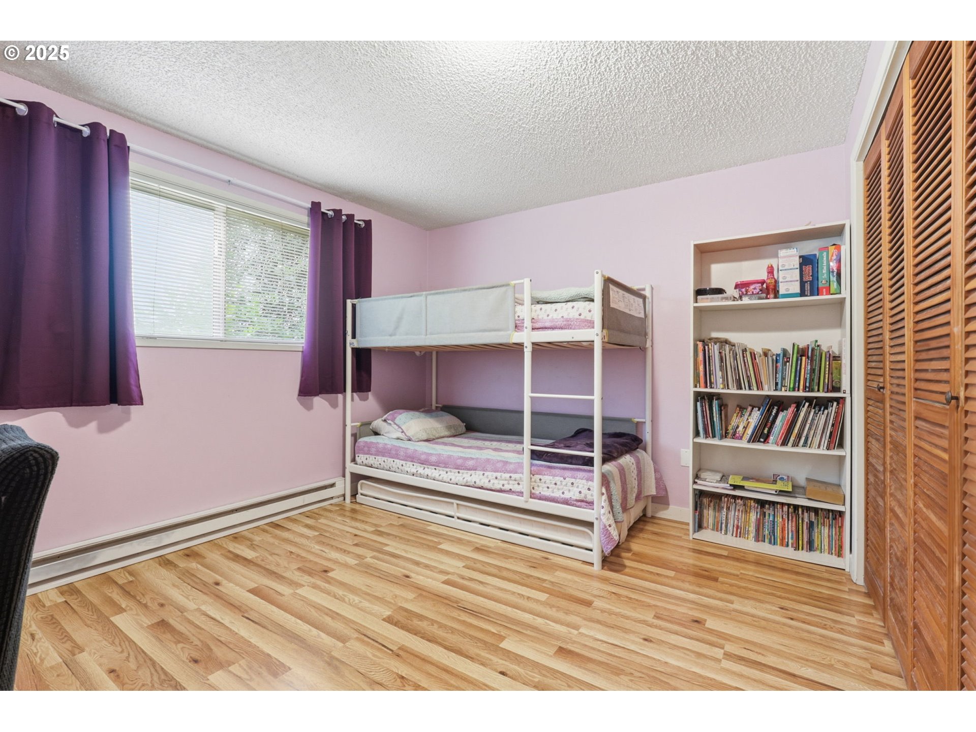 1123 Northwest Ash Street Camas, WA 98607 - Photo 15 of 26 a bedroom with a bed and a book shelf