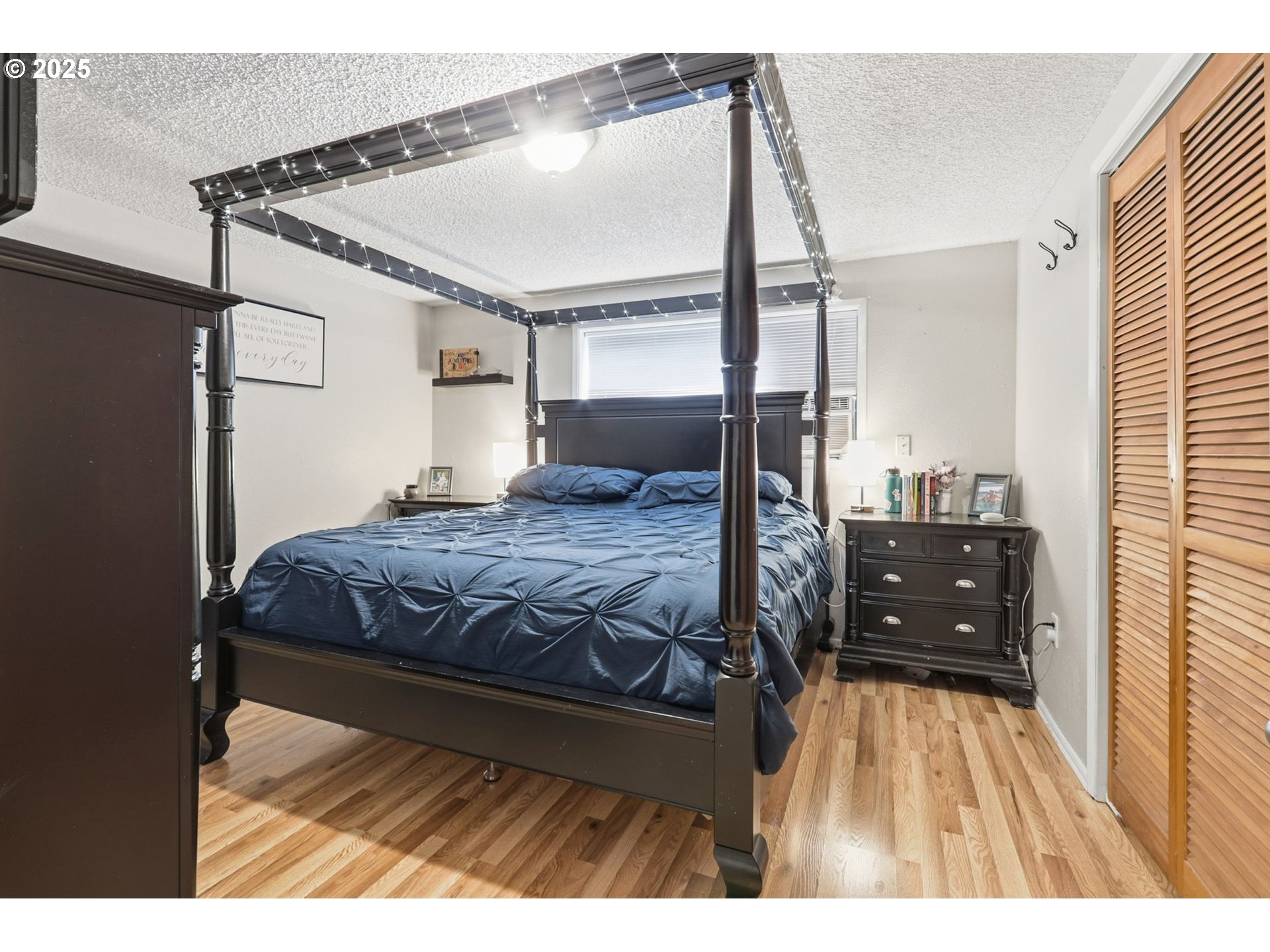 1123 Northwest Ash Street Camas, WA 98607 - Photo 20 of 26 a bedroom with a bed and wooden floor