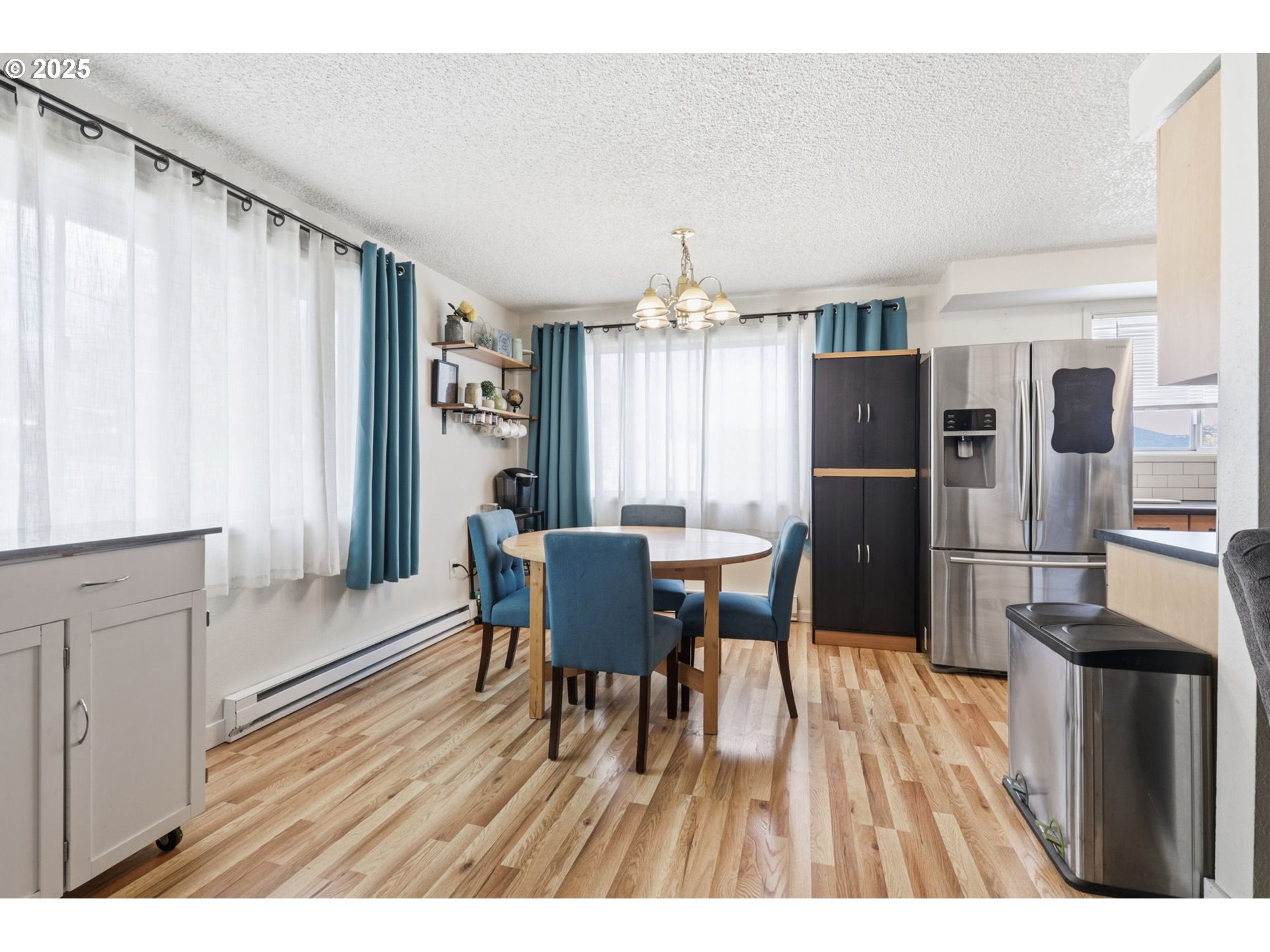 1123 Northwest Ash Street Camas, WA 98607 - Photo 6 of 26 a dining room with furniture a chandelier and wooden floor