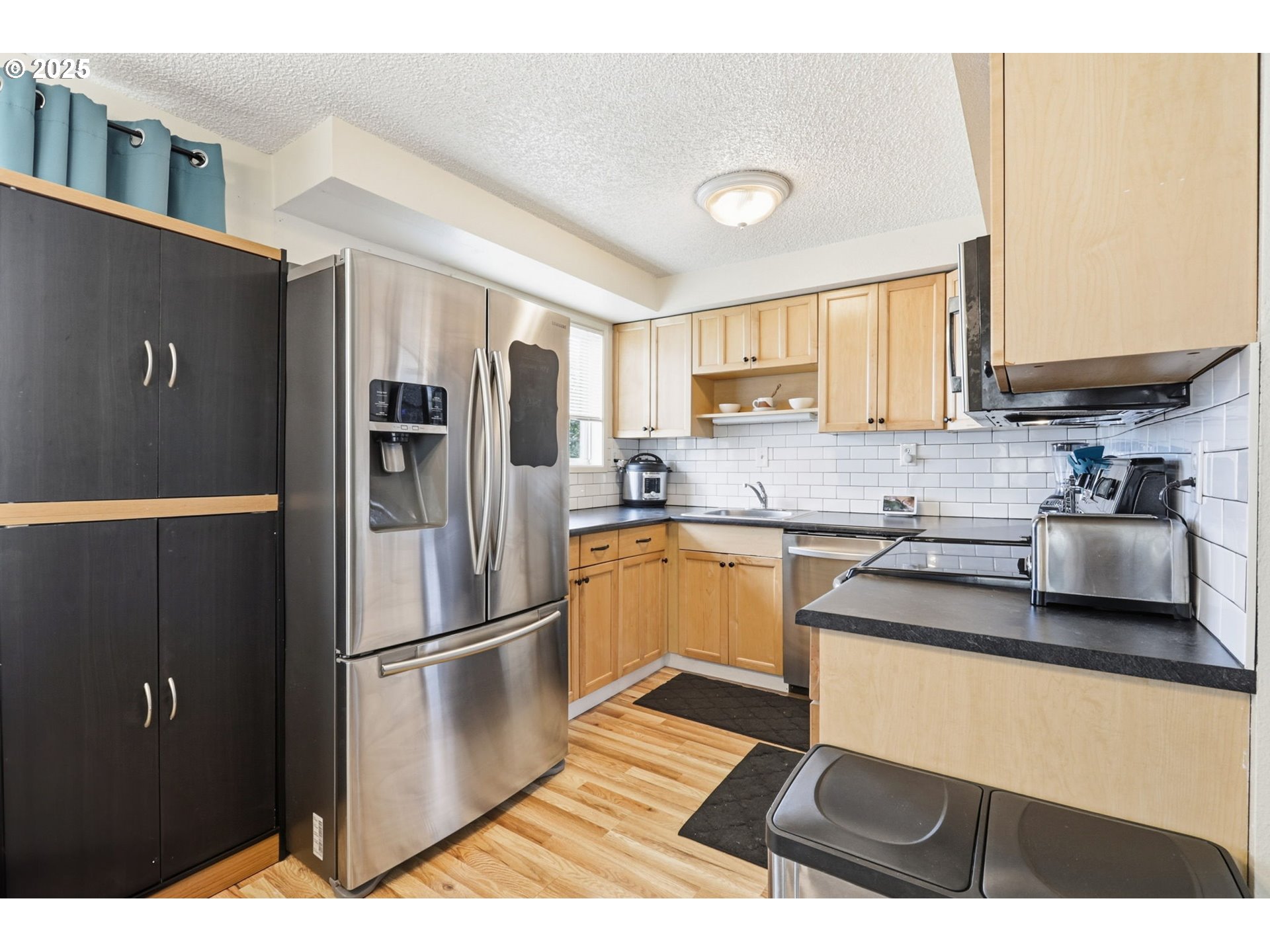 1123 Northwest Ash Street Camas, WA 98607 - Photo 8 of 26 a kitchen with stainless steel appliances granite countertop a refrigerator sink and microwave