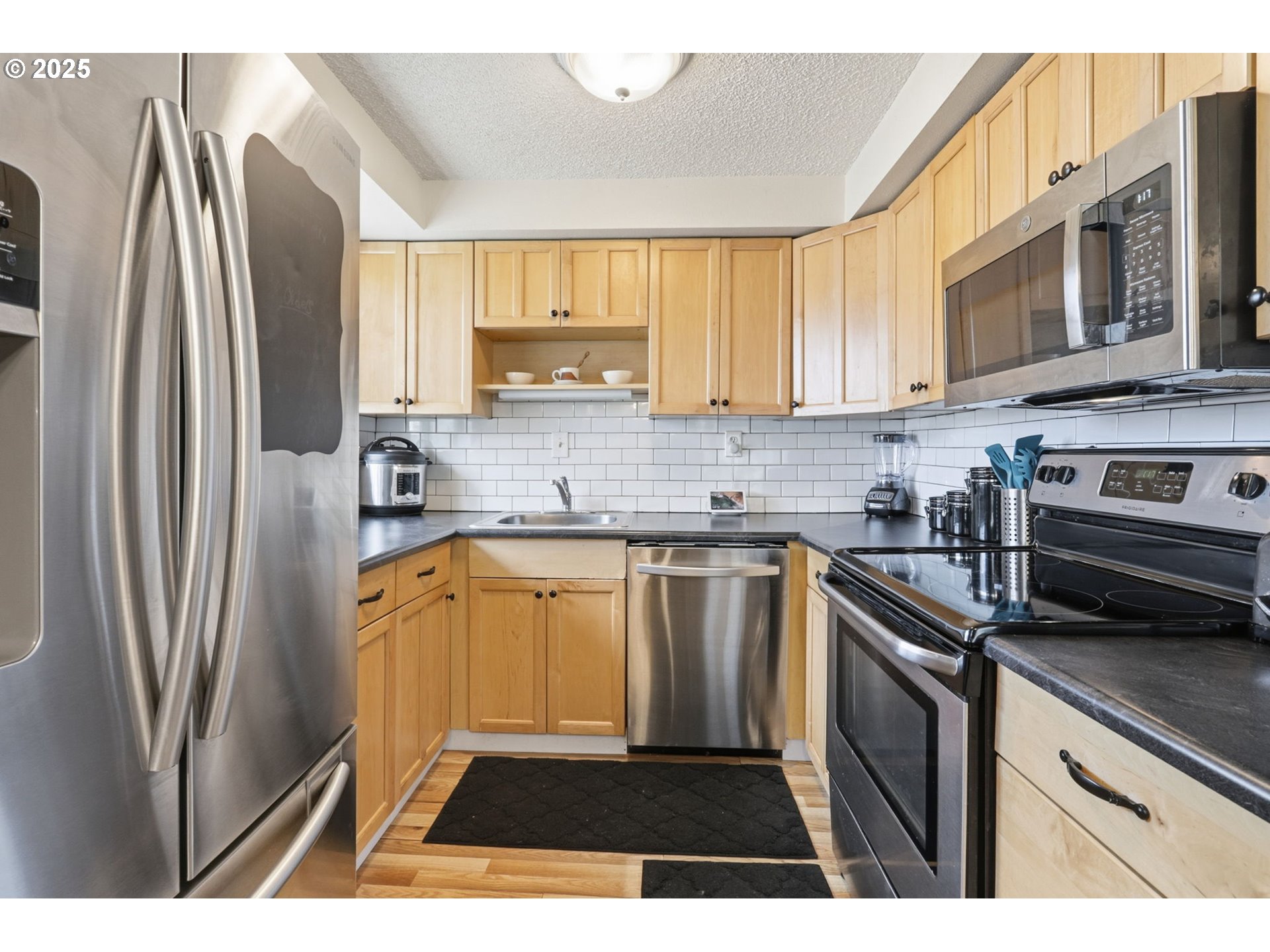 1123 Northwest Ash Street Camas, WA 98607 - Photo 9 of 26 a kitchen with stainless steel appliances a refrigerator sink and microwave