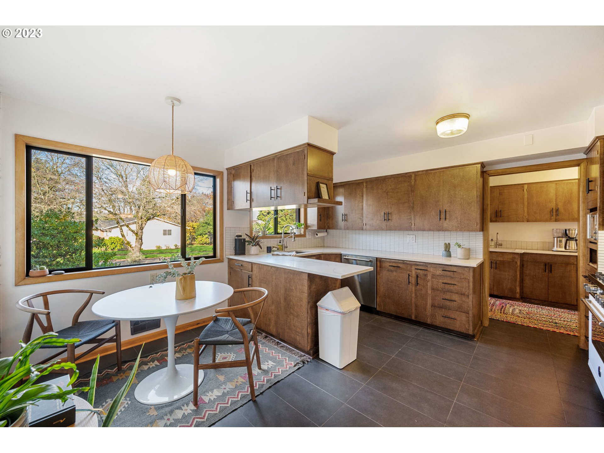 4020 Northeast Rosa Parks Way Portland, OR 97211 - Photo 13 of 48 a kitchen with a table chairs stove and cabinets