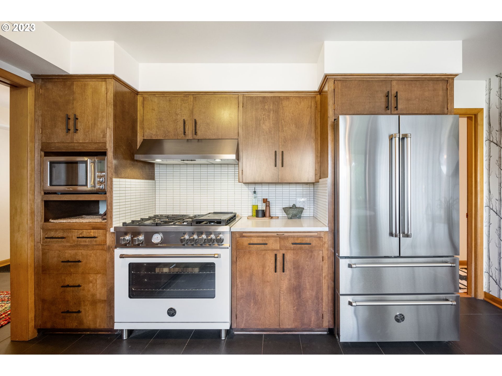 4020 Northeast Rosa Parks Way Portland, OR 97211 - Photo 16 of 48 a kitchen with stainless steel appliances granite countertop a refrigerator stove and cabinets