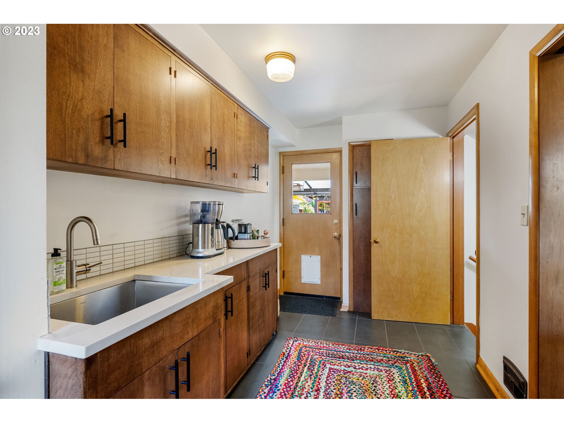 4020 Northeast Rosa Parks Way Portland, OR 97211 - Photo 20 of 48 a kitchen with a sink a refrigerator and cabinets