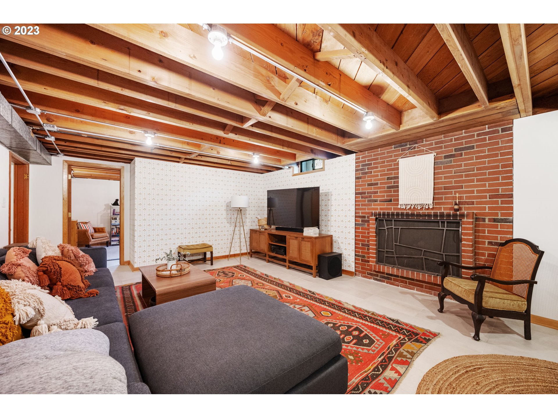 4020 Northeast Rosa Parks Way Portland, OR 97211 - Photo 30 of 48 a living room with furniture a flat screen tv and a floor to ceiling window