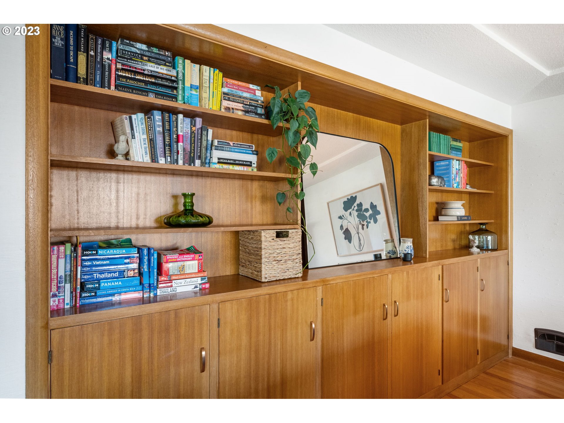 4020 Northeast Rosa Parks Way Portland, OR 97211 - Photo 9 of 48 a cabinet with painting on the wall and a book shelf