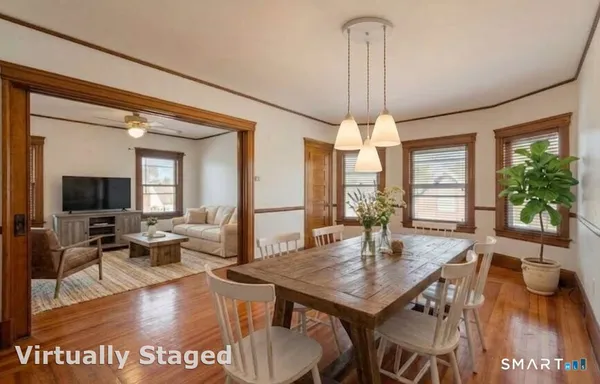 a view of a dining room with furniture window and wooden floor