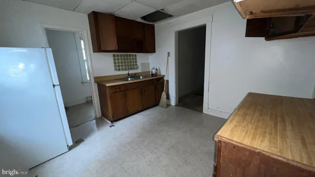 a view of a hallway with workspace and a window