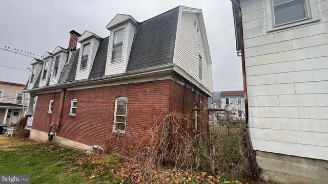 a view of a brick house with many windows