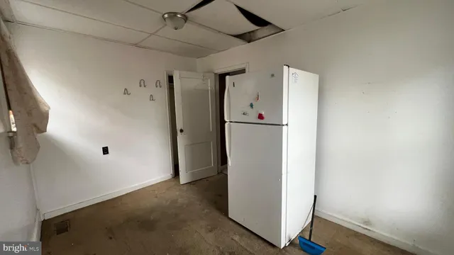 a view of a storage & utility room with a hallway