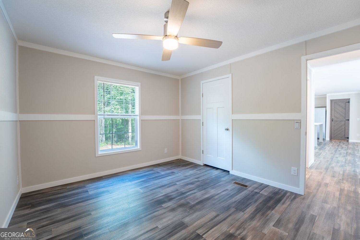 734 Hollywood Church Road Clarkesville, GA 30523 - Photo 22 of 49 an empty room with wooden floor chandelier and windows