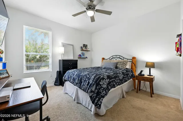 a bedroom with a bed window and a table