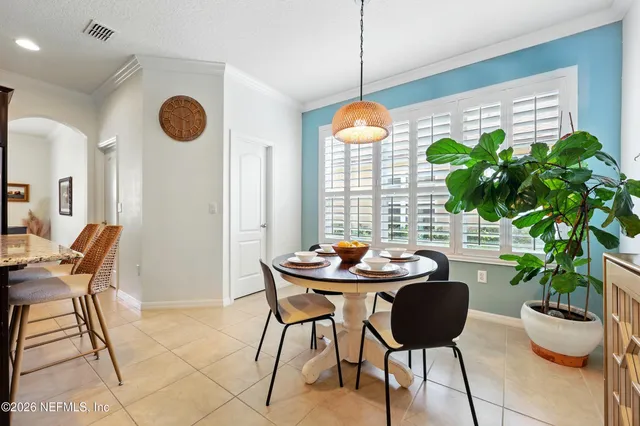 a view of a dining room with furniture and window