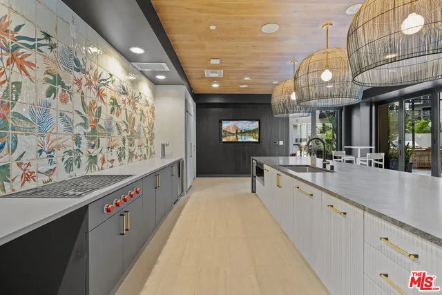 a large hall with stainless steel appliances a large counter top