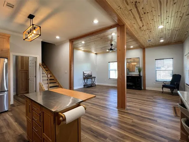 a view of a kitchen with a sink and a refrigerator