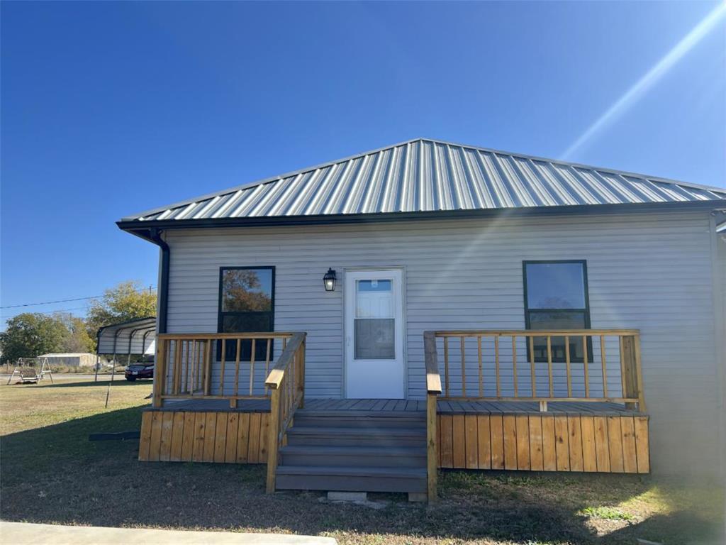 724 Franklin Street Bellevue, TX 76228 - Photo 6 of 32 a front view of a house with a yard
