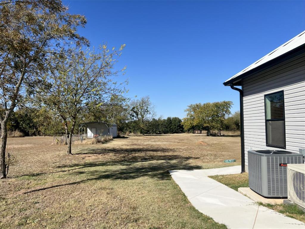 724 Franklin Street Bellevue, TX 76228 - Photo 8 of 32 a view of a house with a yard