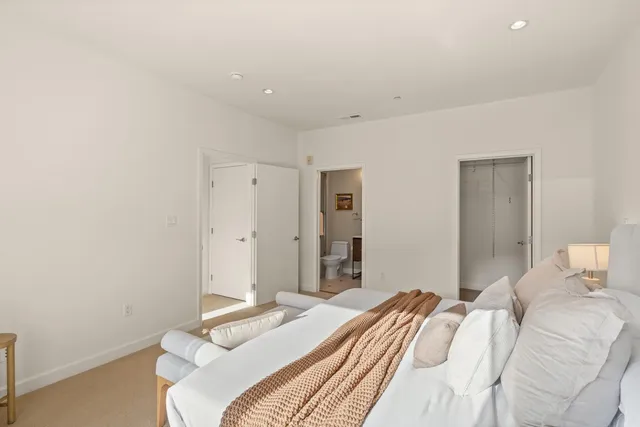 a bedroom with a bed and a mirror