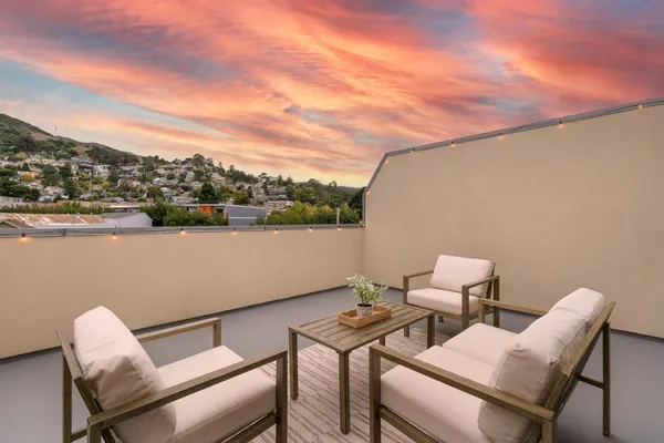 a balcony with a table and chairs