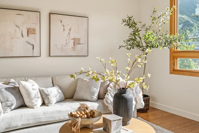 a living room with furniture flowerpot and wooden floor