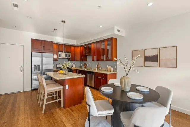a open kitchen with stainless steel appliances kitchen island granite countertop a sink and cabinets