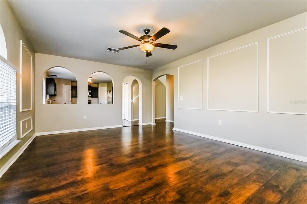 10405 Fly Fishing Street Riverview, FL 33569 - Photo 2 of 15 wooden floor in an empty room with a window
