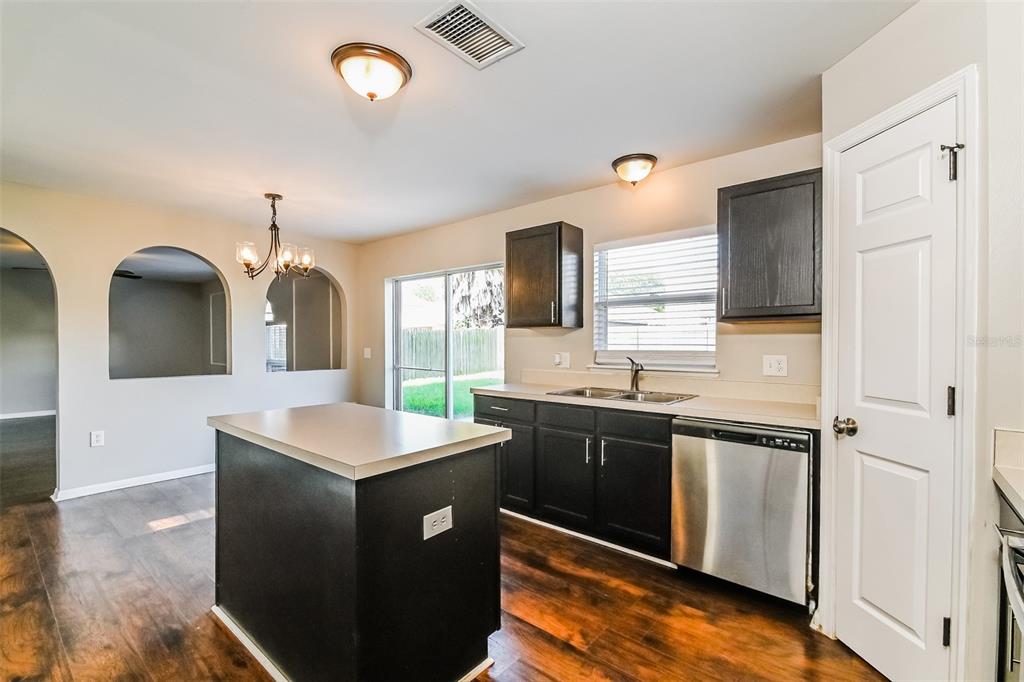 10405 Fly Fishing Street Riverview, FL 33569 - Photo 5 of 15 a kitchen with stainless steel appliances granite countertop a sink and a refrigerator