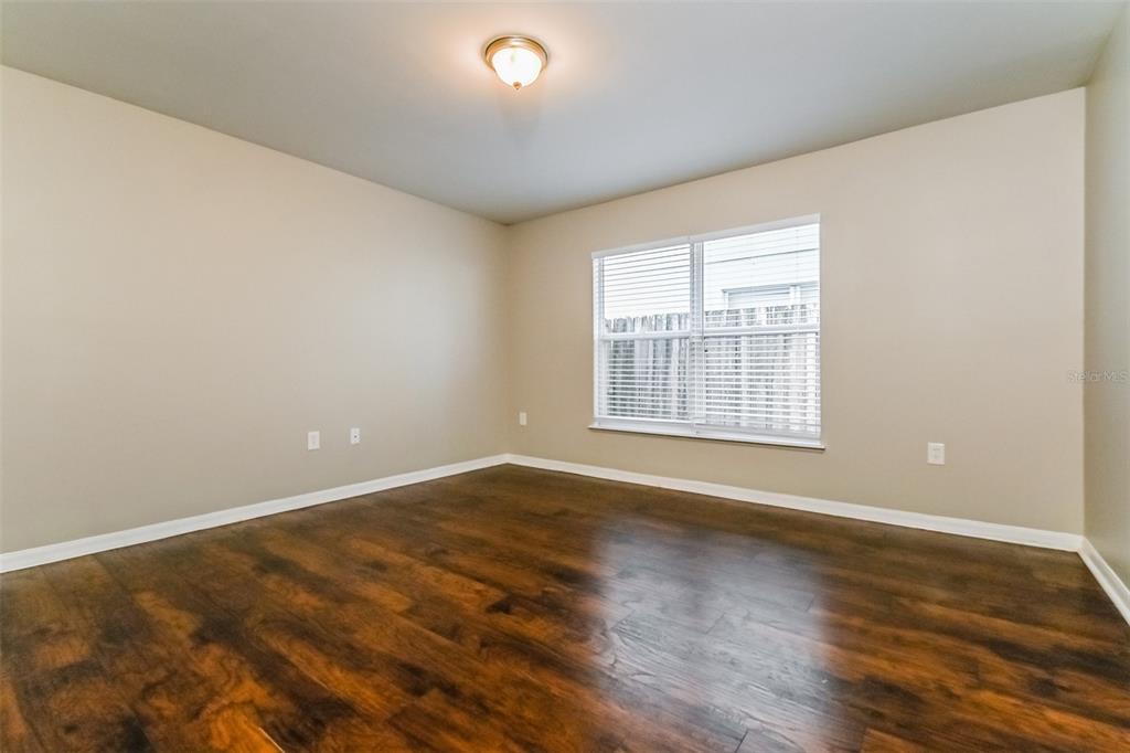 10405 Fly Fishing Street Riverview, FL 33569 - Photo 6 of 15 an empty room with wooden floor and windows