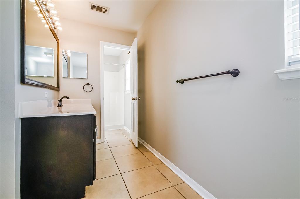 10405 Fly Fishing Street Riverview, FL 33569 - Photo 9 of 15 a bathroom with a double vanity sink and mirror