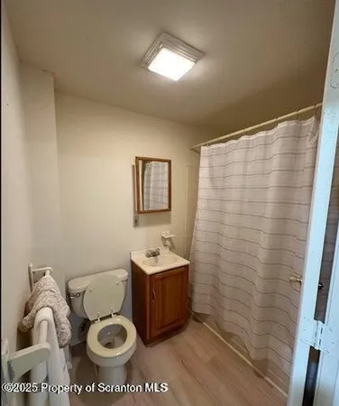 a bathroom with a toilet a sink and a mirror