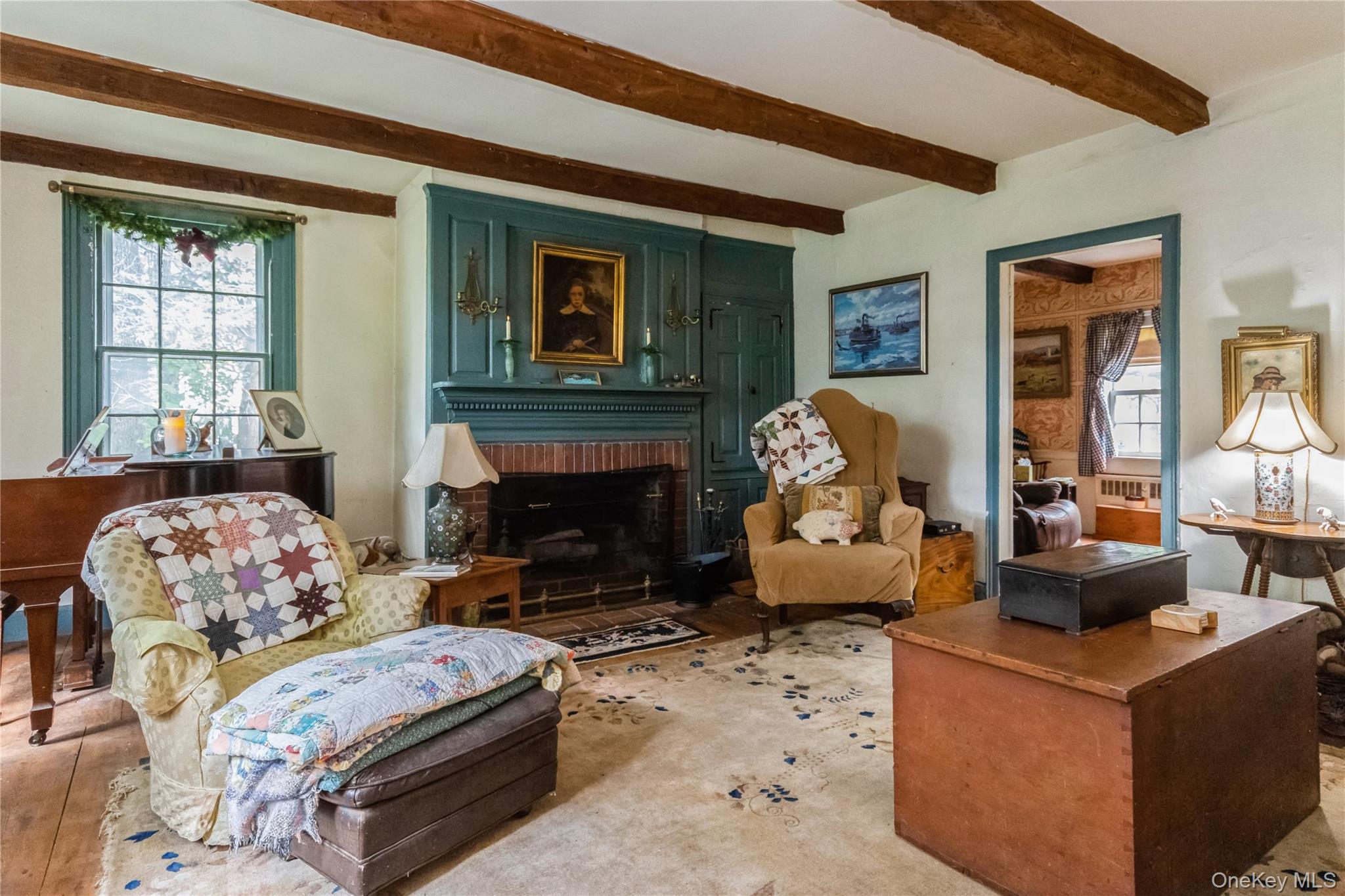 93 Widmer Road Wappingers Falls, NY 12590 - Photo 20 of 45 Living room featuring beamed ceiling and a brick fireplace