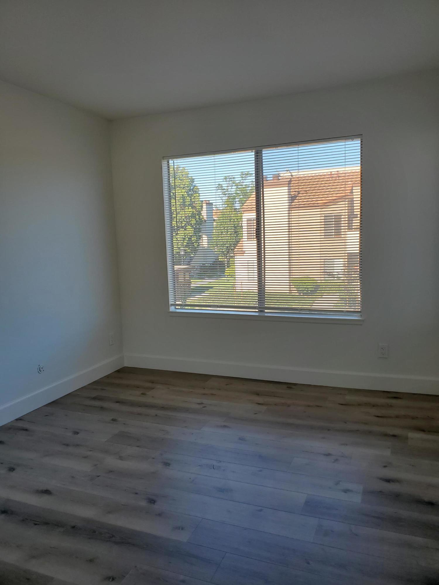 1760 Sinaloa Road, Unit 265 Simi Valley, CA 93065 - Photo 4 of 39 an empty room with wooden floor and windows