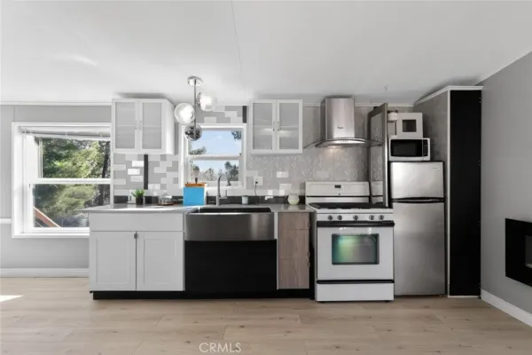 a kitchen with stainless steel appliances granite countertop a stove a sink and a refrigerator