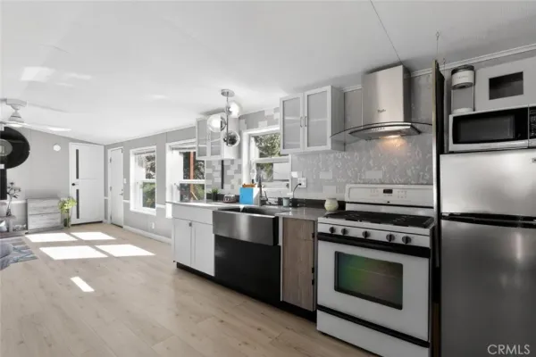 a kitchen with stainless steel appliances and white cabinets