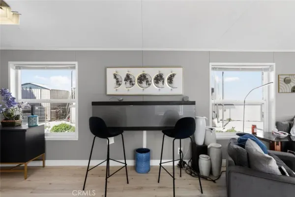 a living room with furniture and a painting on the wall