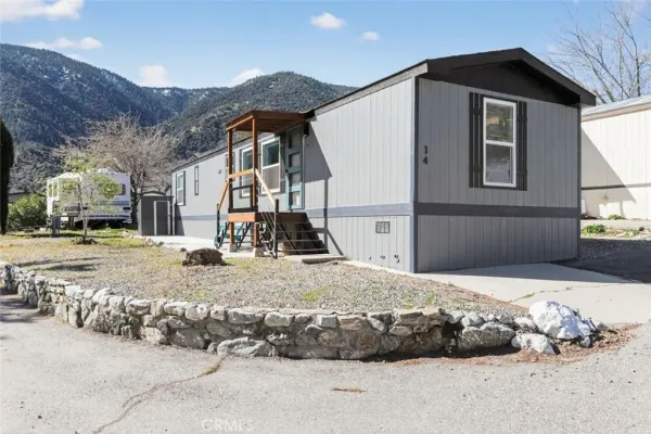 a view of a house with snow on the side of the road