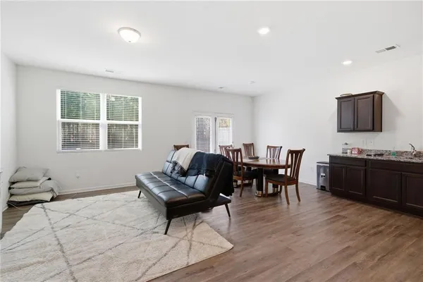 a view of a dining room with furniture and wooden floor