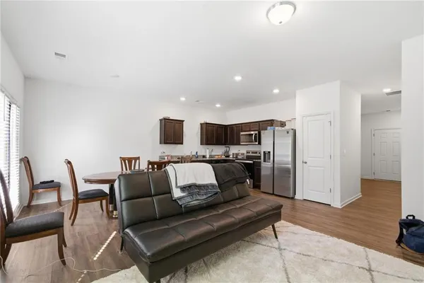 a living room with furniture and kitchen view