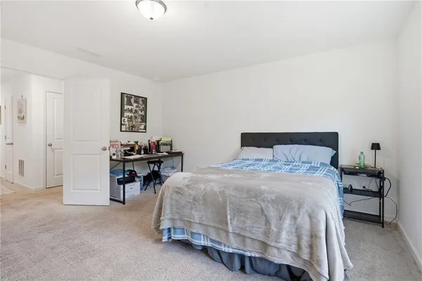 a bedroom with a bed and a table in it