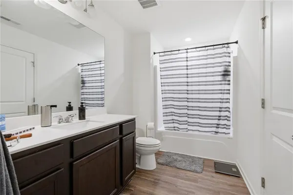 a bathroom with a sink a toilet and a window