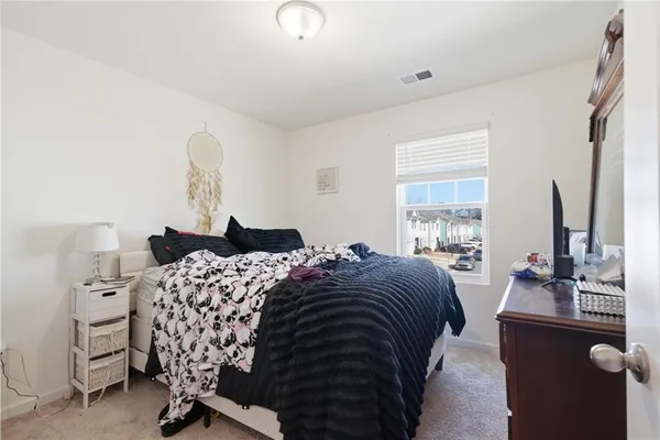 a bedroom with a bed and a dresser