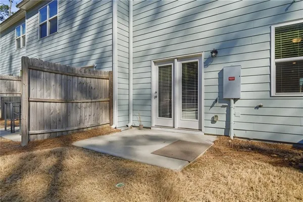 a backyard of a house with basket ball court and wooden fence