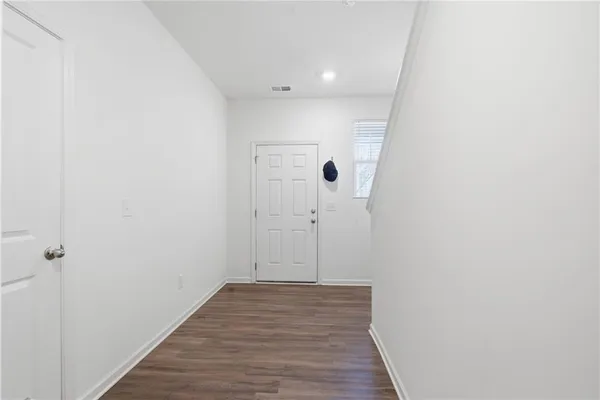 a view of a hallway with wooden floor