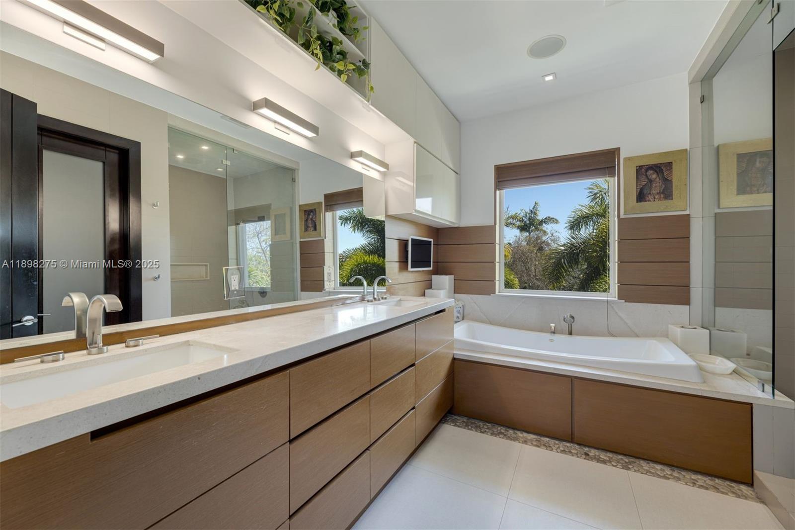 765 Allendale Road Key Biscayne, FL 33149 - Photo 12 of 29 a bathroom with a large tub double vanity sink and a large mirror