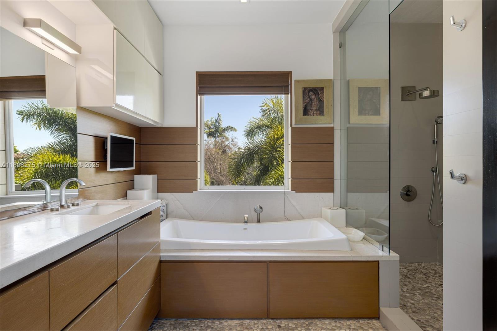 765 Allendale Road Key Biscayne, FL 33149 - Photo 13 of 29 a bathroom with a bathtub and a sink