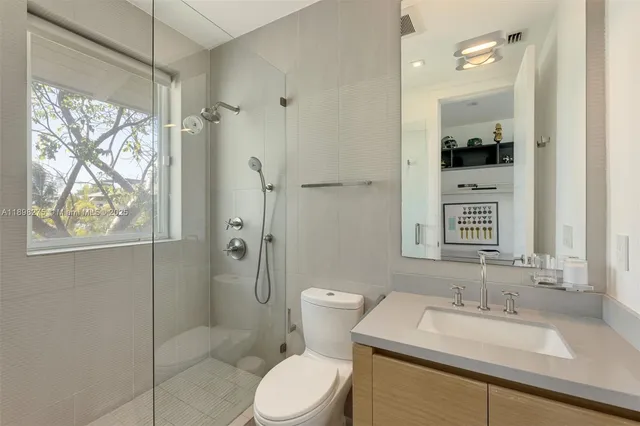 a bathroom with a sink toilet and shower
