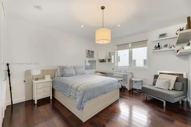 a spacious bedroom with a bed and a chandelier