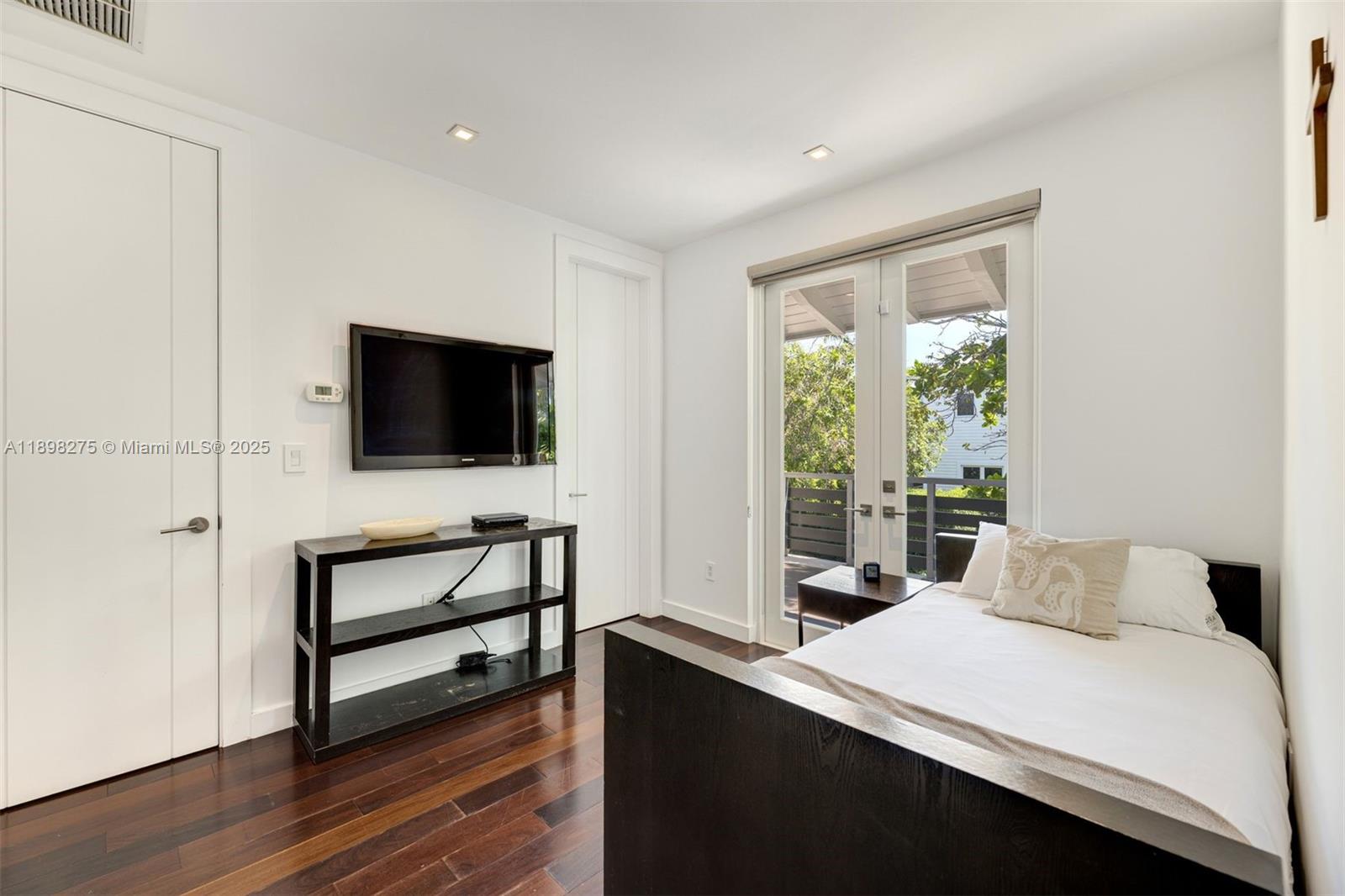 765 Allendale Road Key Biscayne, FL 33149 - Photo 22 of 29 a bedroom with a bed and a flat screen tv