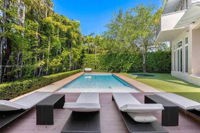 a white and chair sitting in the backyard of a house