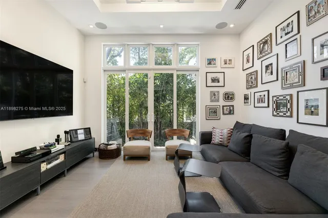 a living room with furniture large window and a flat screen tv